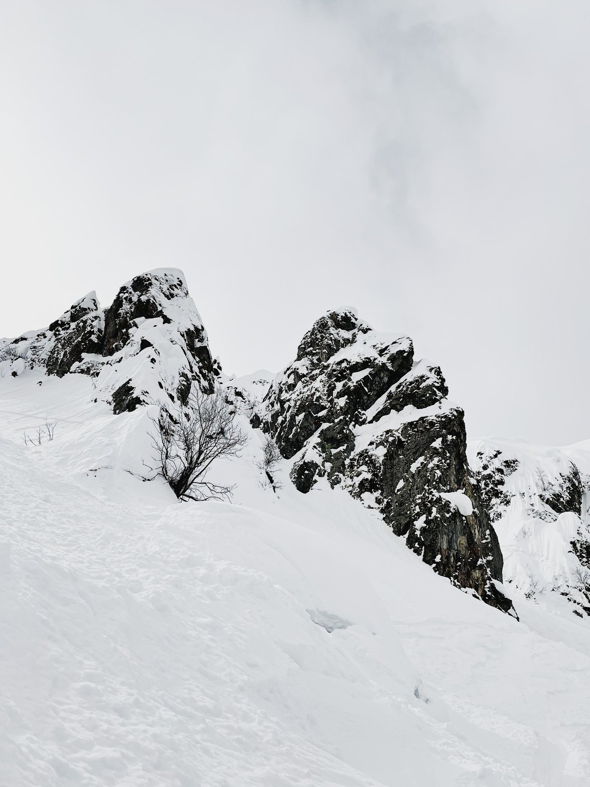 A Snow Covered Mountain Under the White Sky